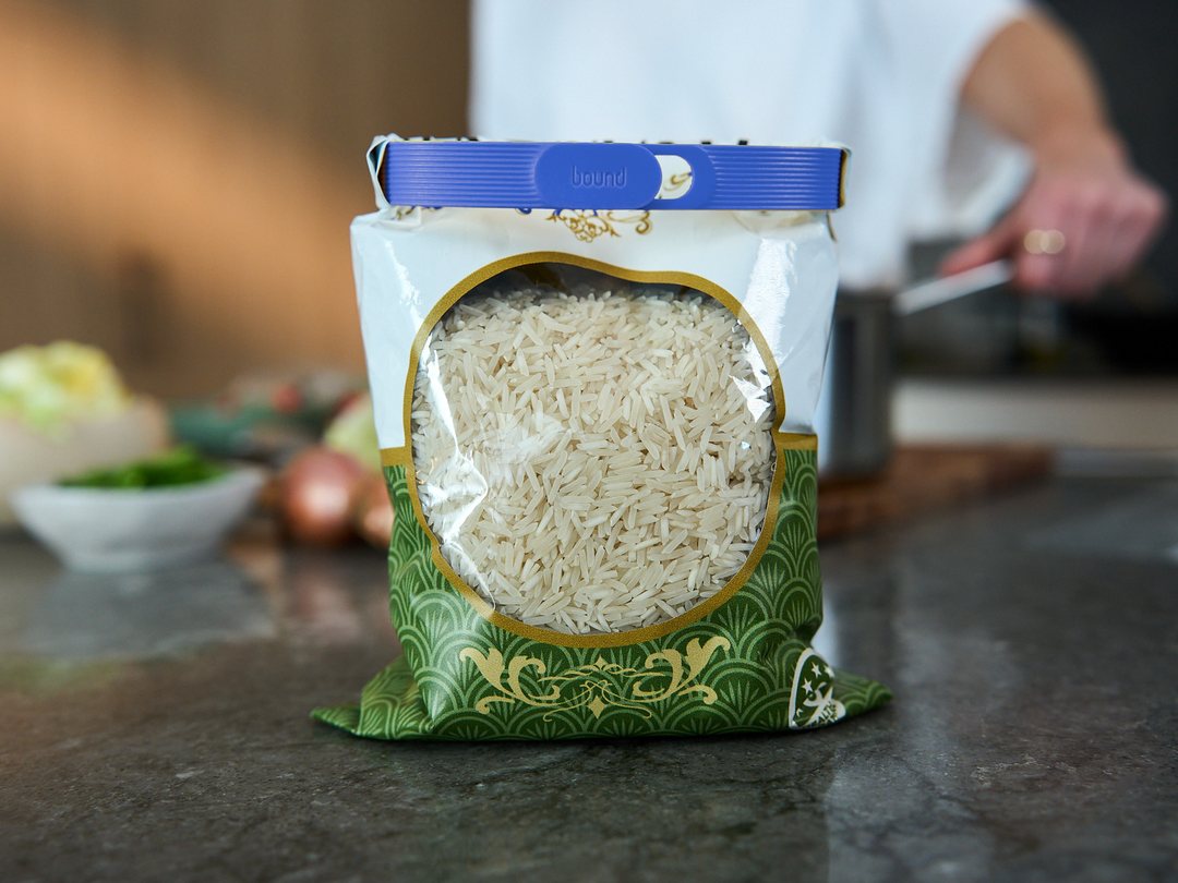 A bag of basmati rice on a kitchen bench, sealed with a Blueberry Looplock